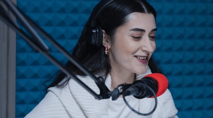 Woman speaking into a red microphone for voice acting