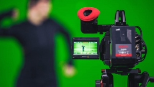 man on green screen with camera
