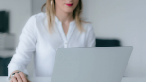 woman on laptop researching on how to become a better voice actor