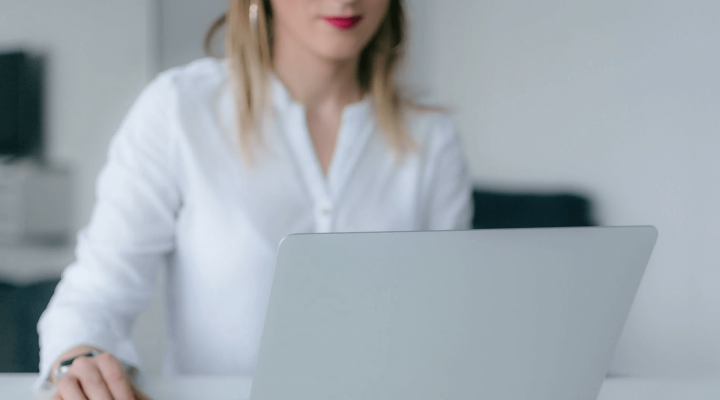 woman on laptop researching on how to become a better voice actor