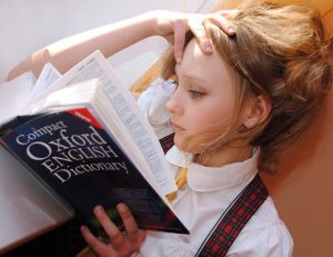 Woman studying dictionary for english pronounciation